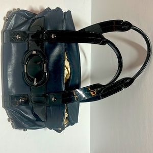 Unique navy blue leather bag with black patent leather trim and buckle